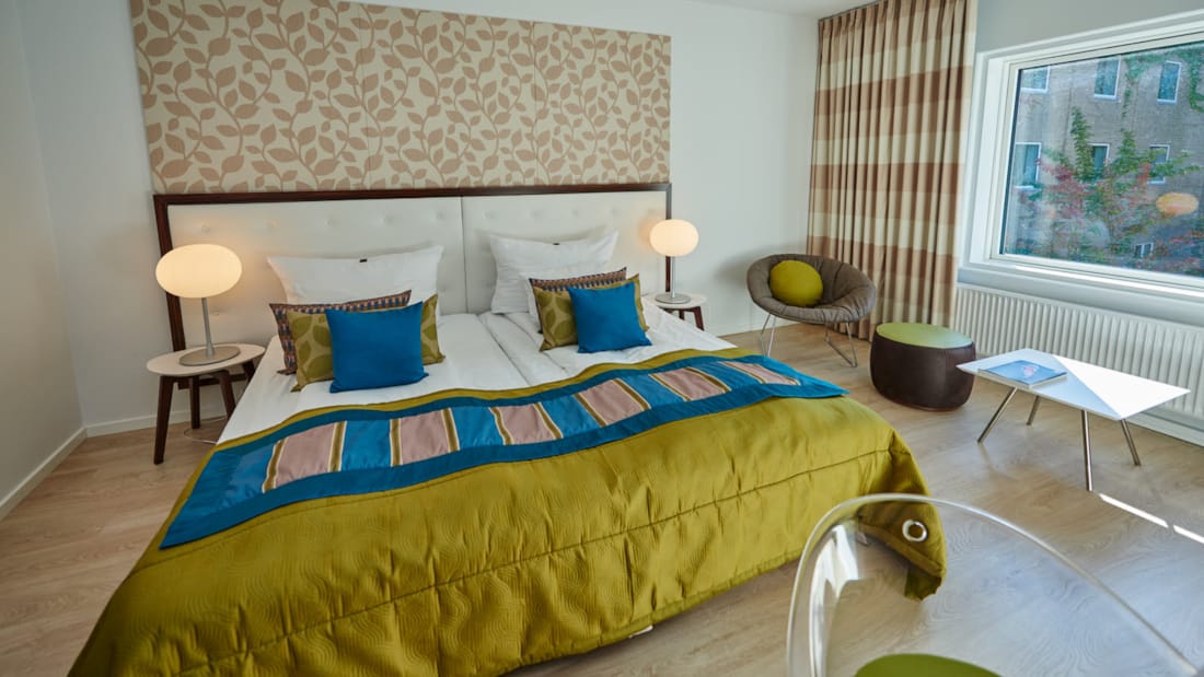 Superior Room double bed in fresh colours in a large, bright room with a view