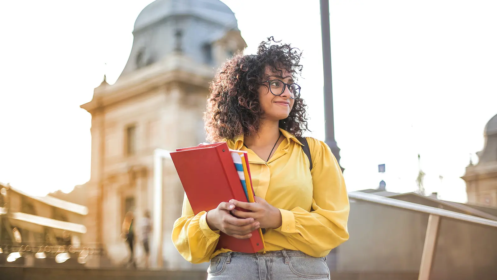 Student with yellow jacket and briefcase in hand
