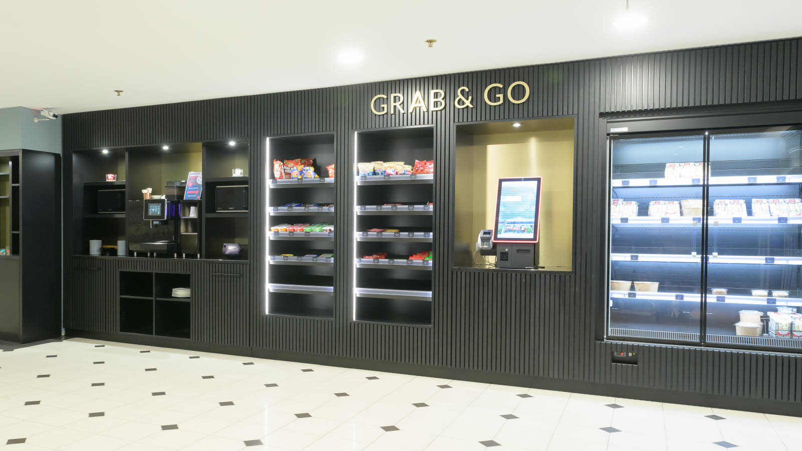 Self-service kiosk with coffee machine, snacks, food and payment terminal.