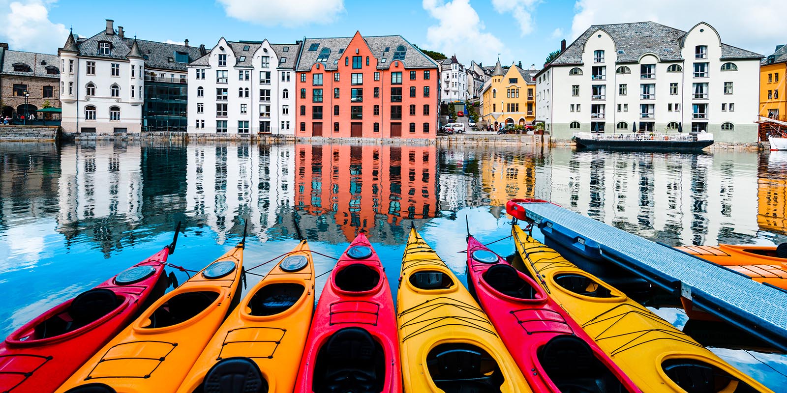 Many kayaks in a row in the water in the centre of Ålesund