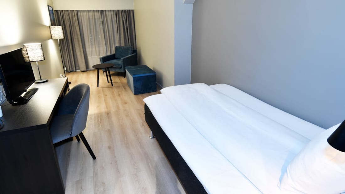 Bed in standaard eenpersoonskamer in Thon Hotel Baronen