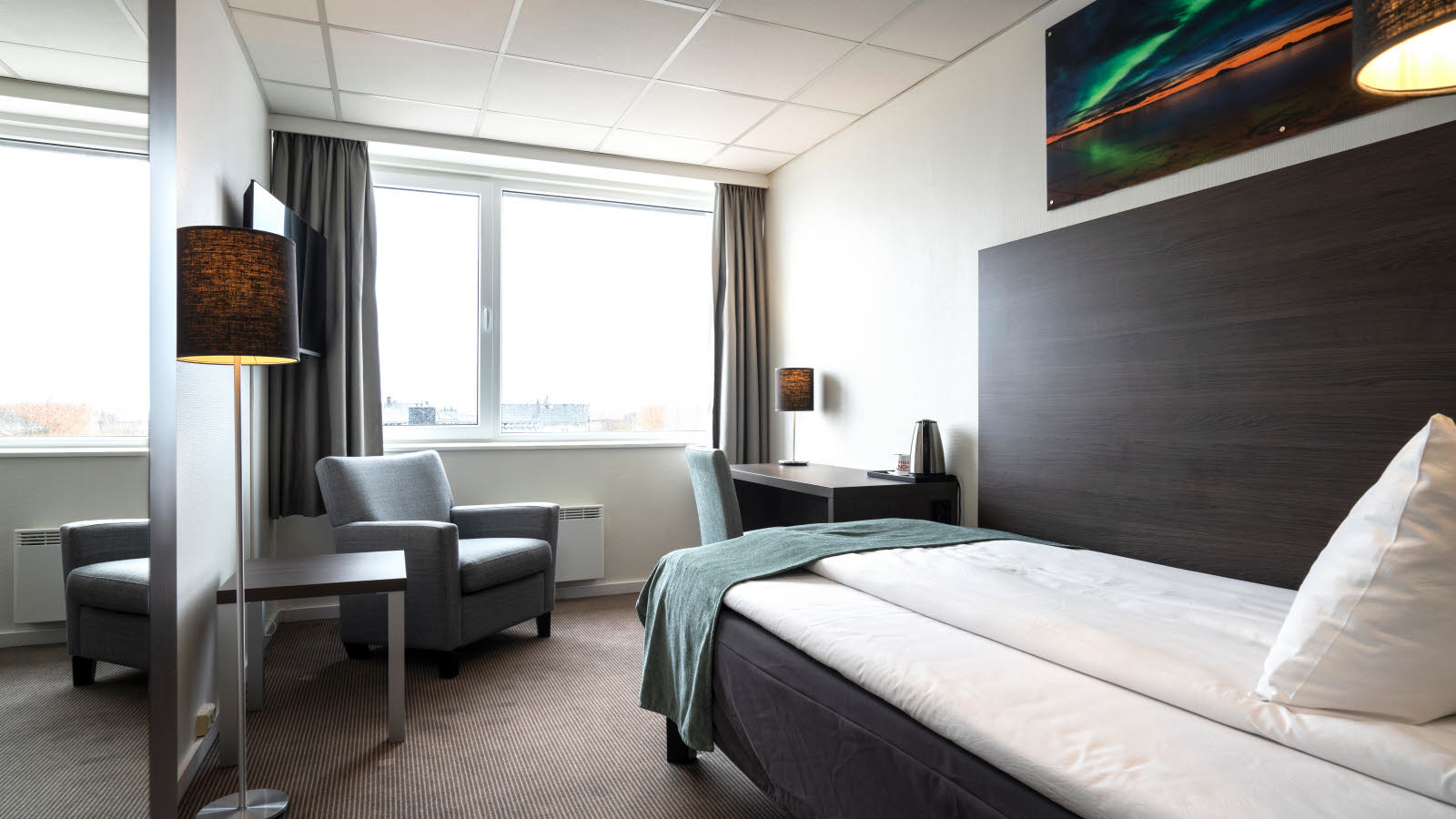 Bed in standaard eenpersoonskamer in Thon Hotel Andrikken