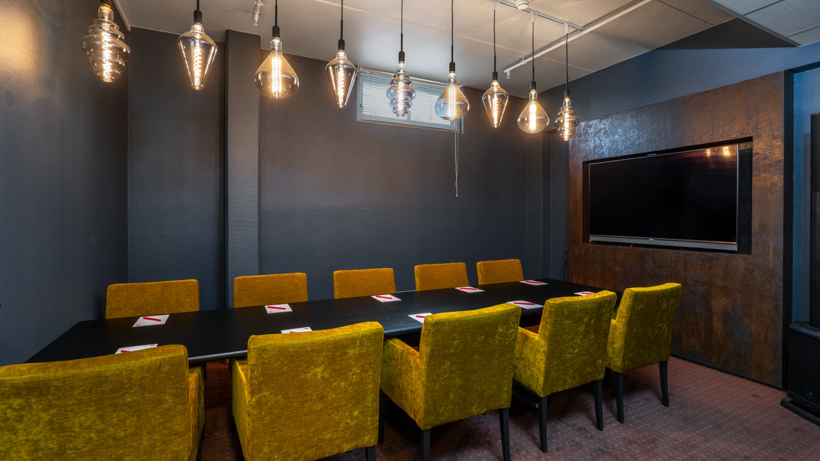 Landego meeting room with long table, chairs and TV