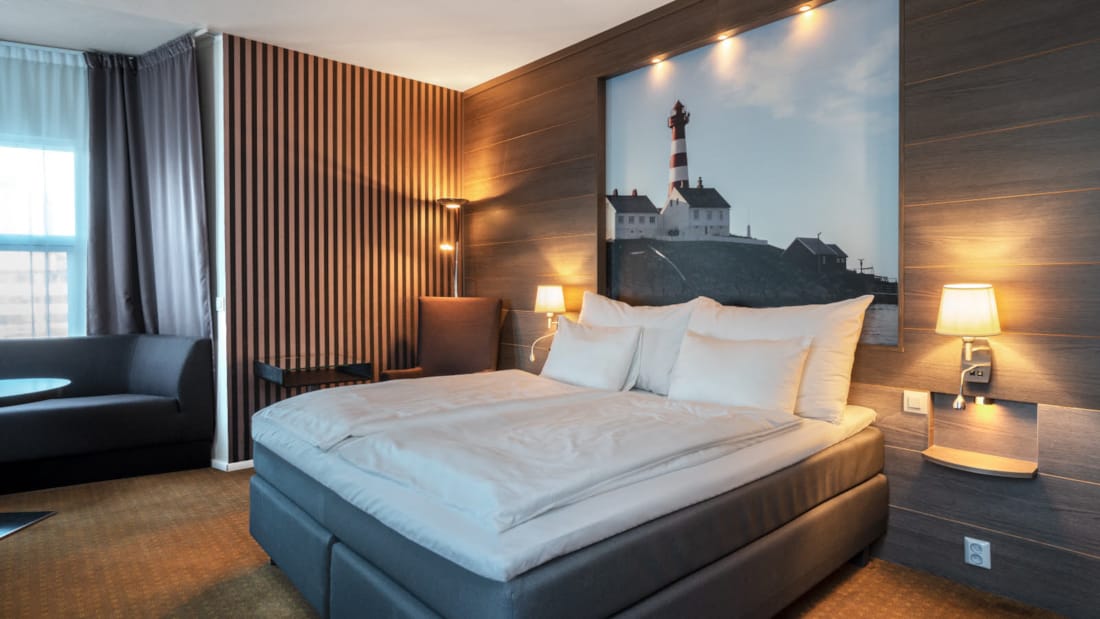 Thon Hotel Skagen Junior Suite met tweepersoonsbed, zitje bij het raam, schilderij en licht