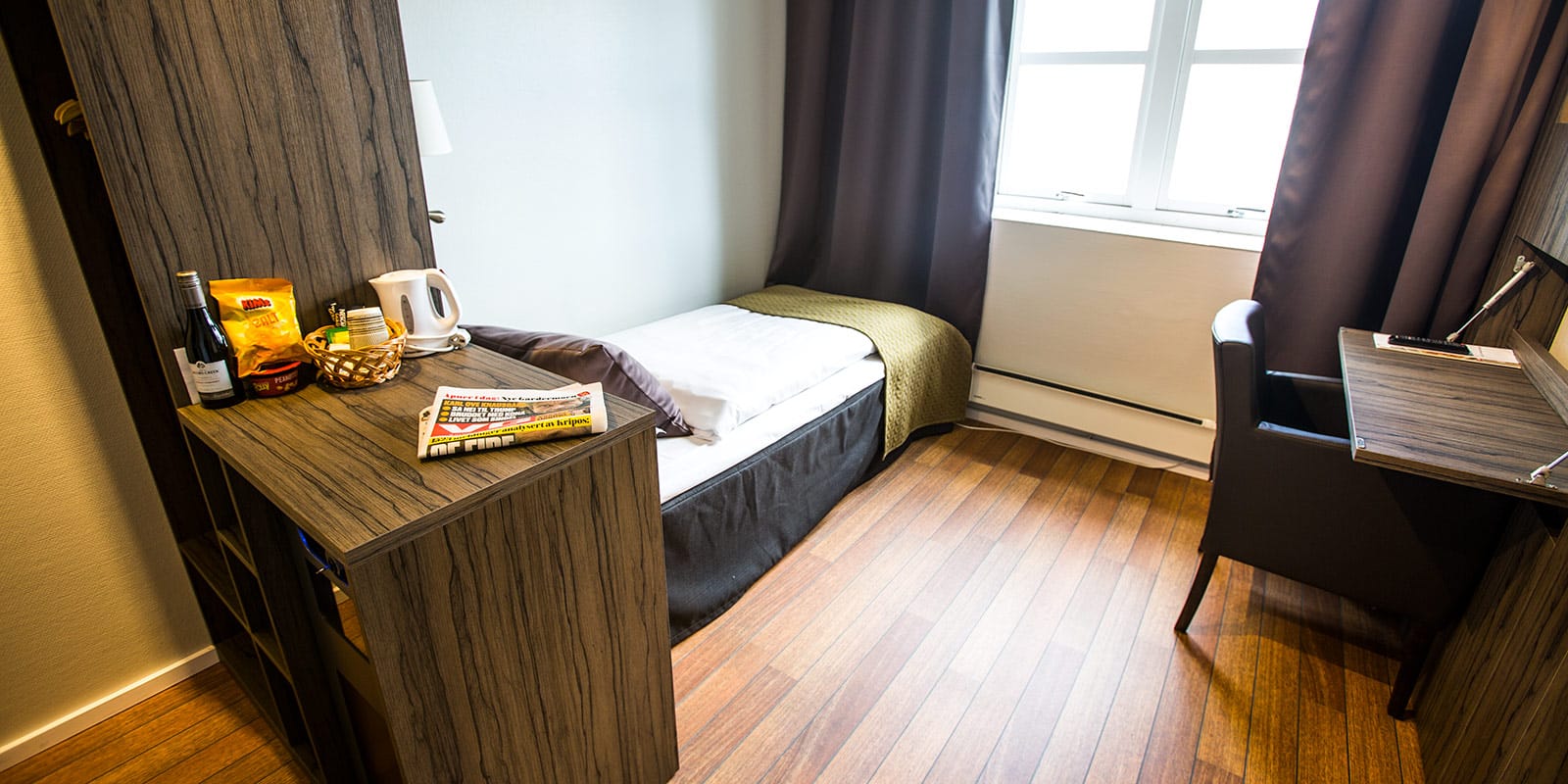 Bett eines Einzelzimmers im Skagen Hotel