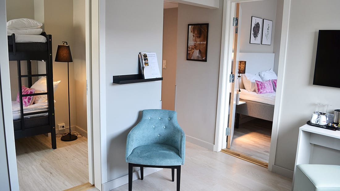 Opholdsrum med udsigt til to soveværelser i familieværelse på Hotel Central i Elverum
