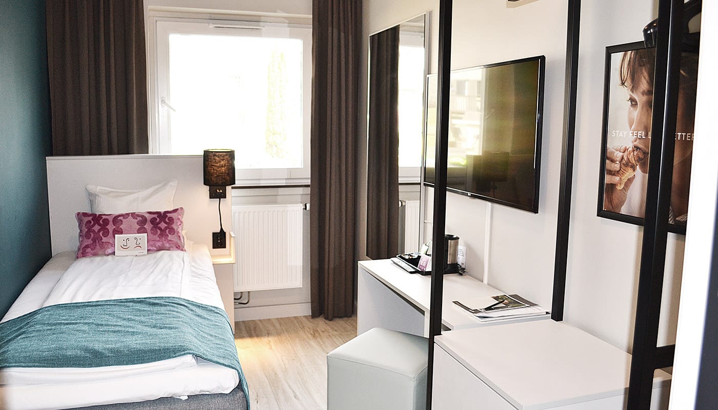 Bett eines Einzelzimmers im Hotel Central in Elverum 