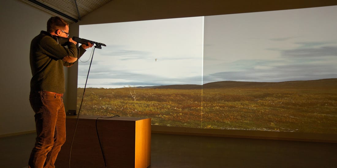 Man trying on a shooting simulator at the Hunting and Fishing Center in Flå