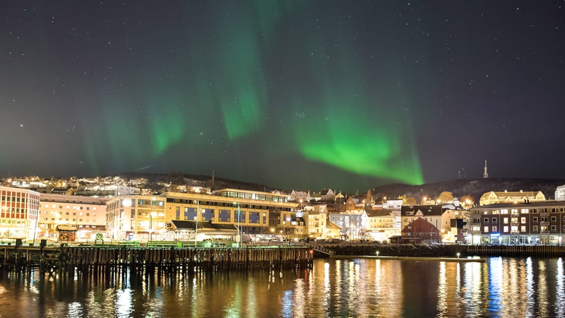 The Northern Lights over the quay in Harstad