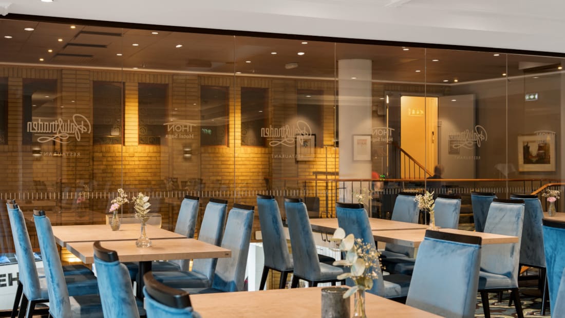 Thon Partner Hotel Saga stort lyst værelse med blå stole i hyggelige lokaler