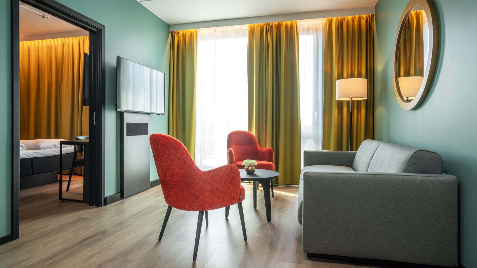 Lounge group in front of large windows in a hotel room at Thon Hotel Snø