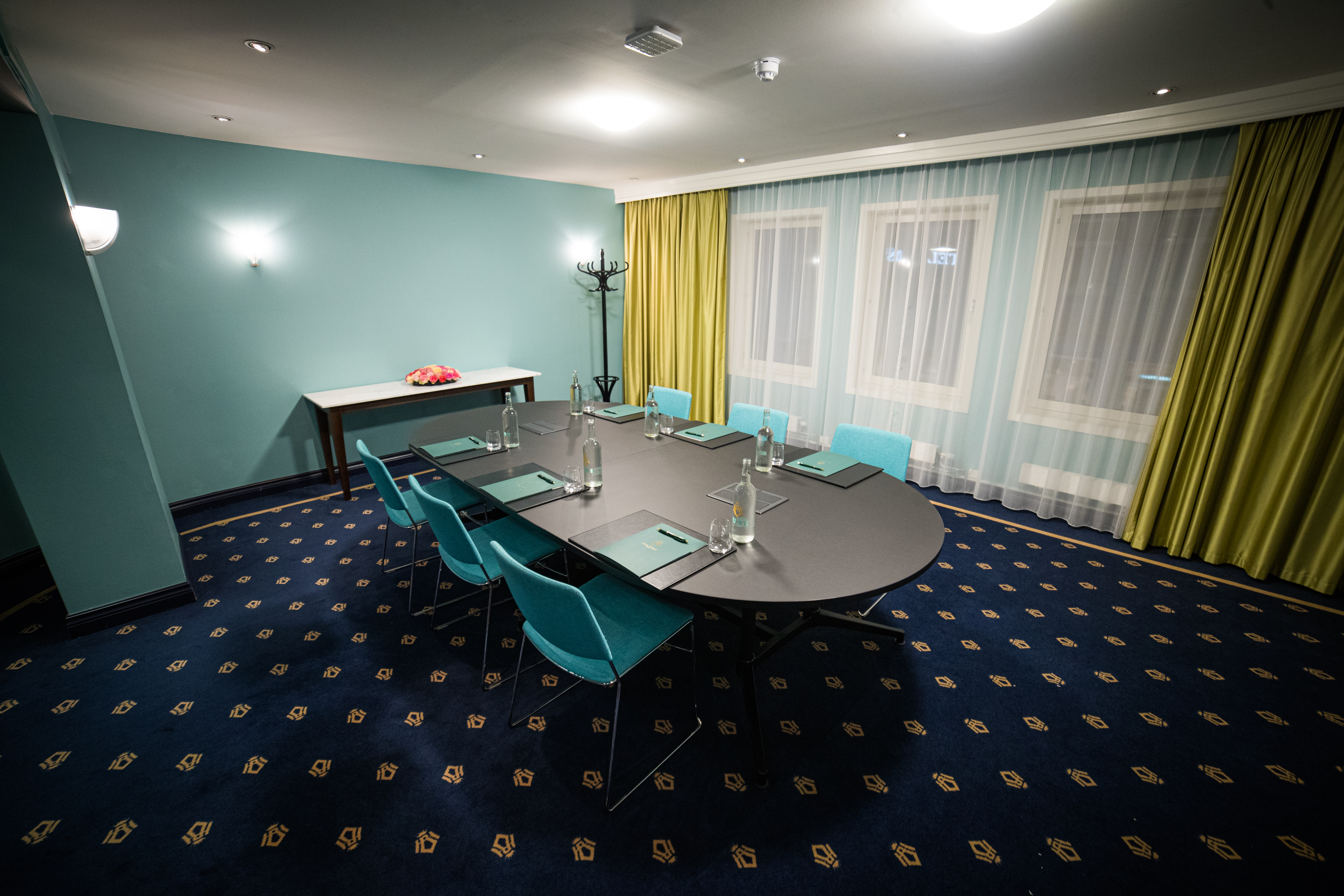 Meeting room with semi-circular table and wall-mounted TV