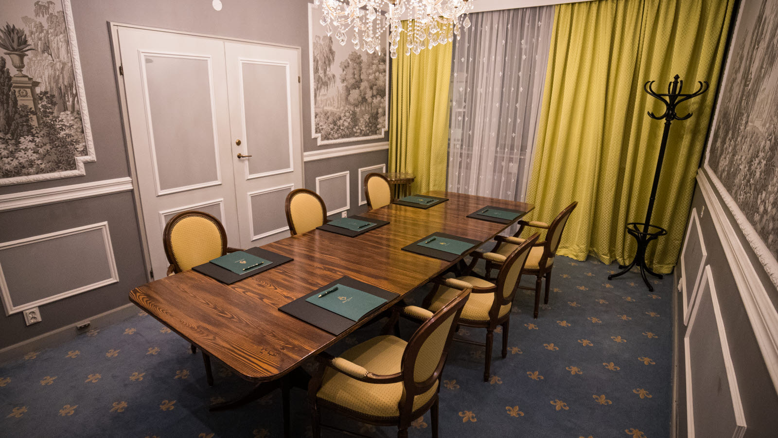 Meeting room with large window, long table and chairs