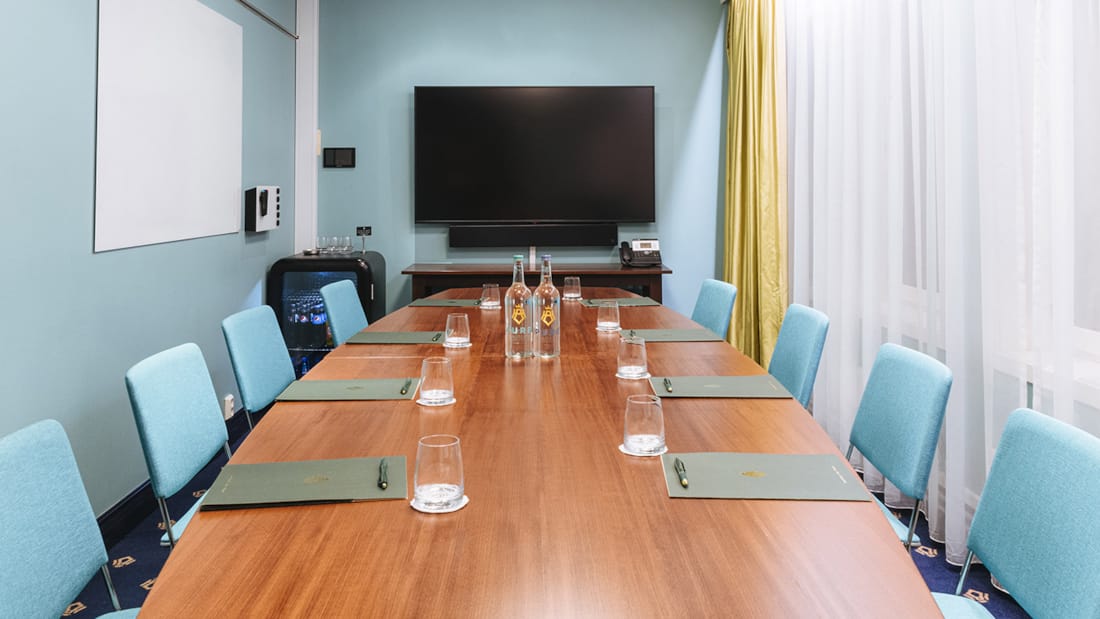 Meeting room with large window, long table and chairs