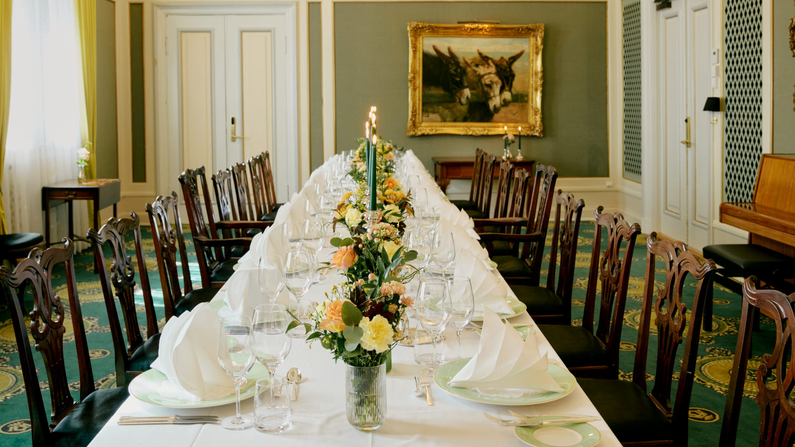 Social room with long table and chandelier
