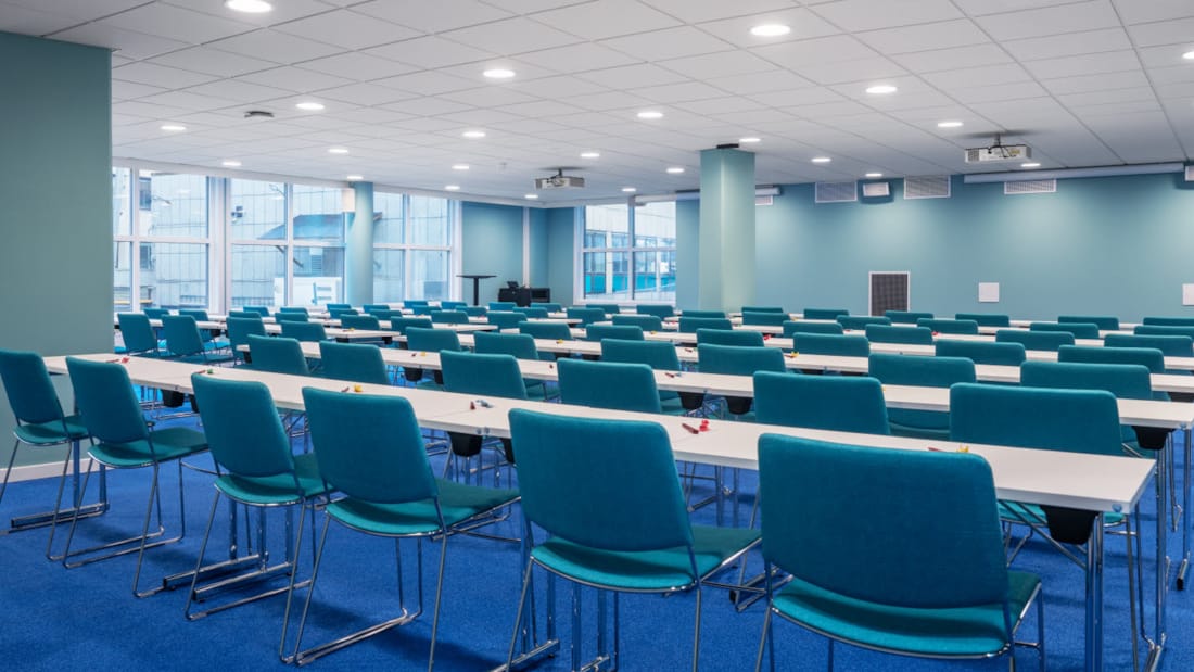 Large meeting room in classroom layout with large windows