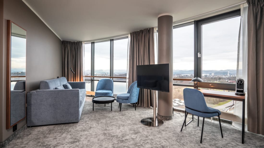Seating area and TV bench in a suite at the Stavanger Forum Hotel