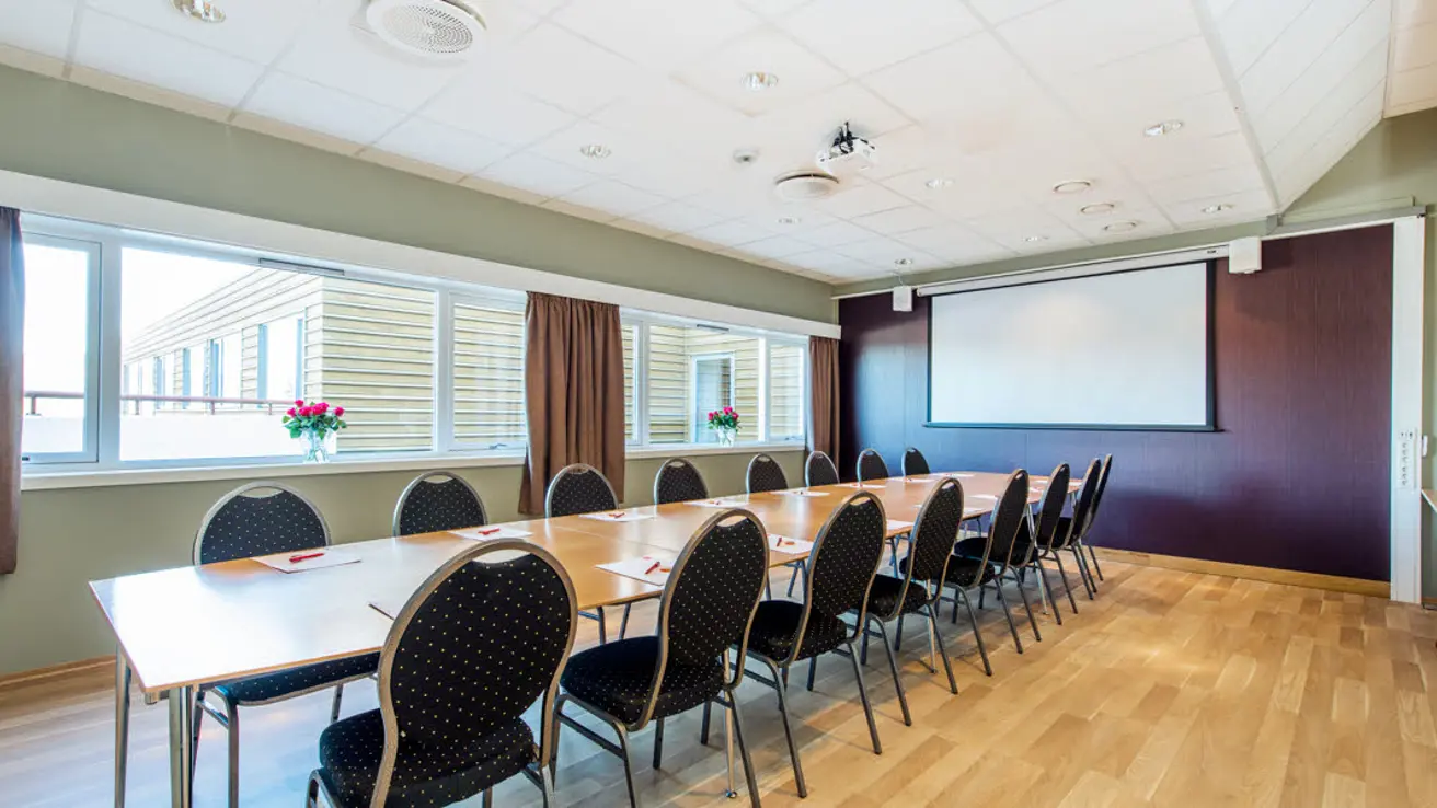 Møterom Hjelmen med whiteboard og prosjektor med plass til 16 stykker i styrebord på Hotel Surnadal