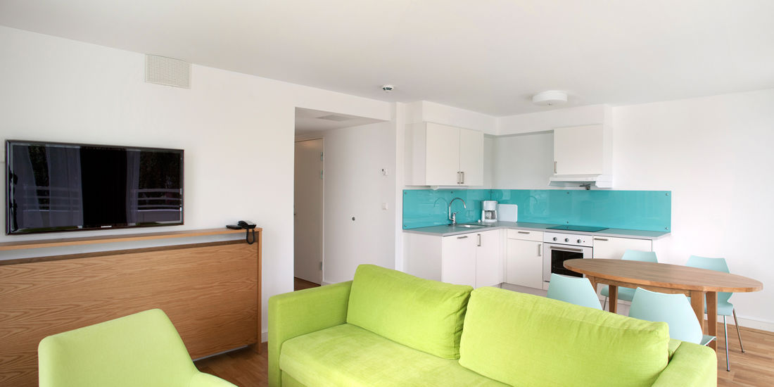 The bed in a four-room apartment at Thon Hotel Sandven