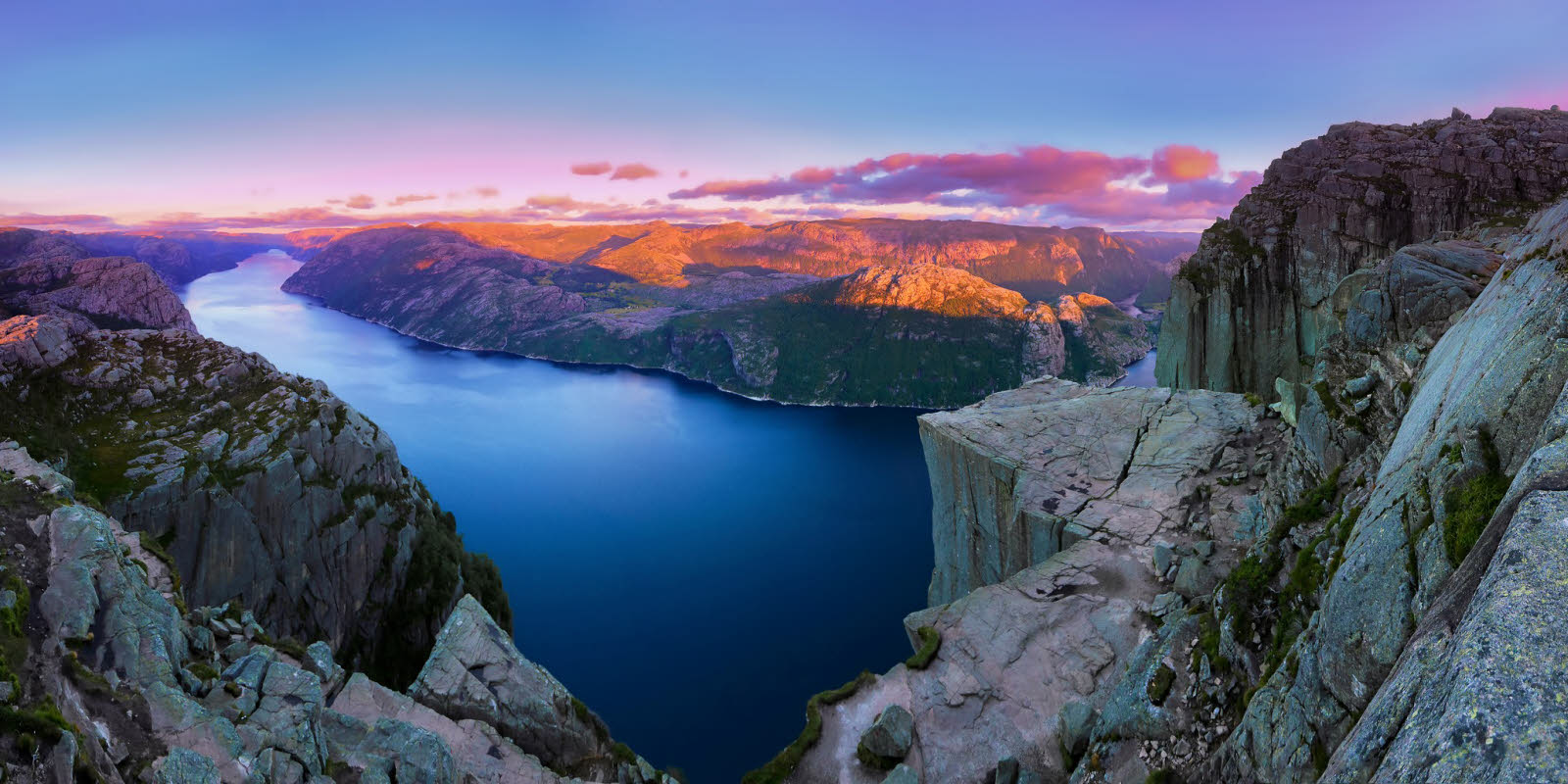 Scenic image of Preikestolen in a rosy-colored sunset Stavanger