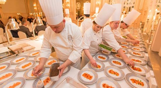 Chefs preparing culinary delights in the kitchen of a Thon hotel