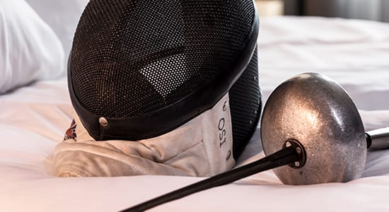 Fencing equipment on a hotel bed