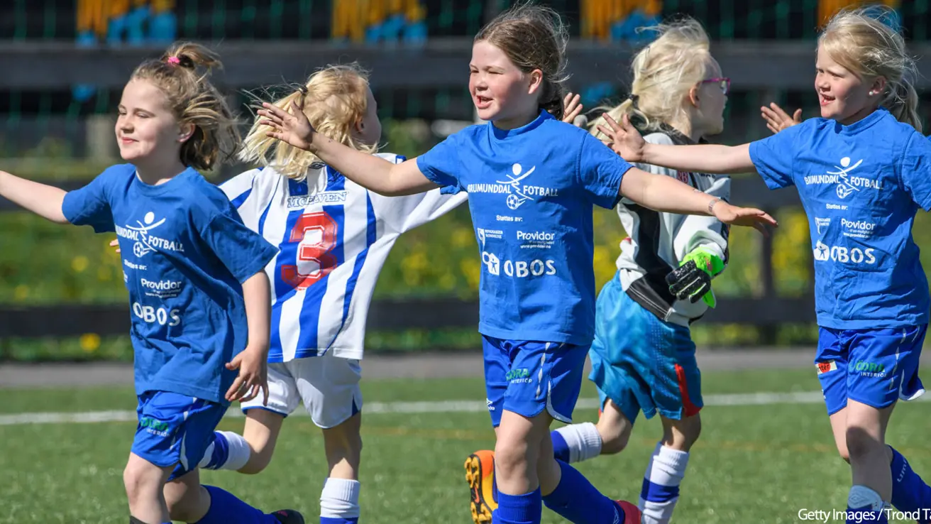 Chidlren in blue football attire on a football field