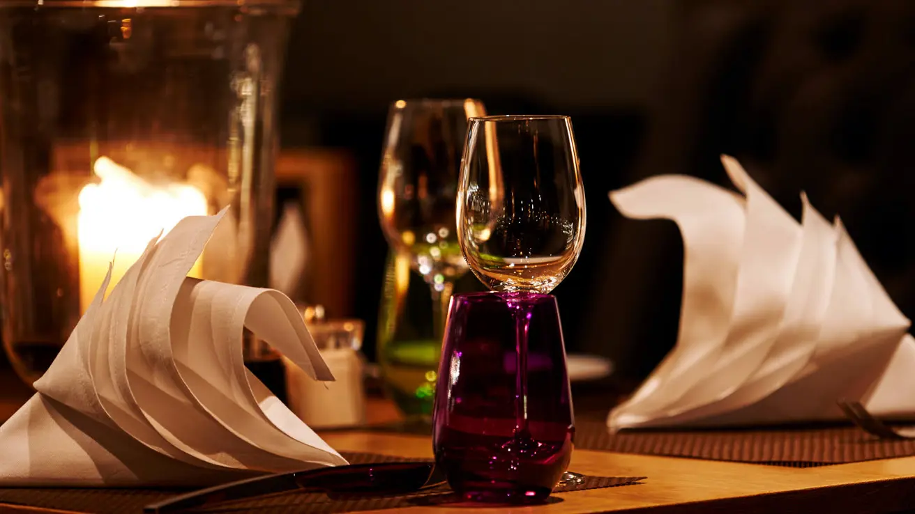 Wine glasses and set table for dinner for two