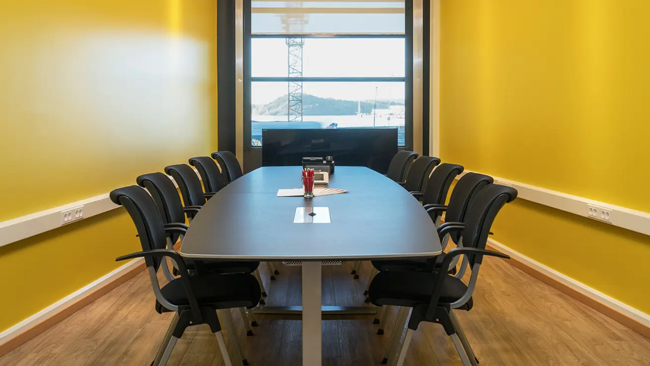 Meeting room with long table and a large window